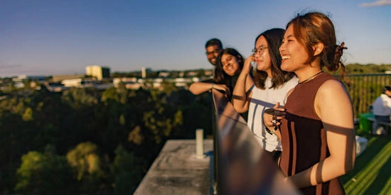 Four Deakin students look out at the view from Deakin Burwood Campus.