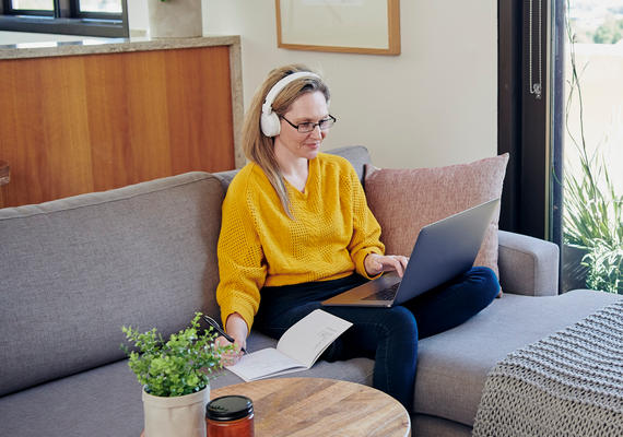 A staff member using a laptop seated at a desk