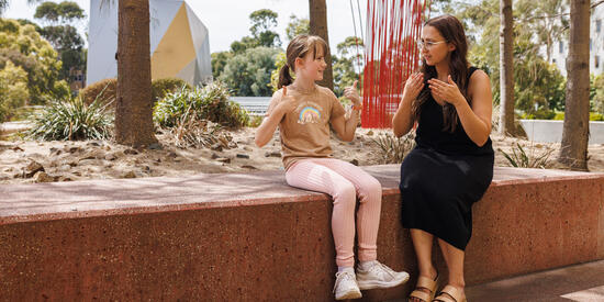 Two people communicating with sign language