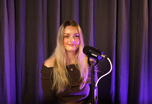 A Deakin Accelerate student sits in an interview room talking to a microphone