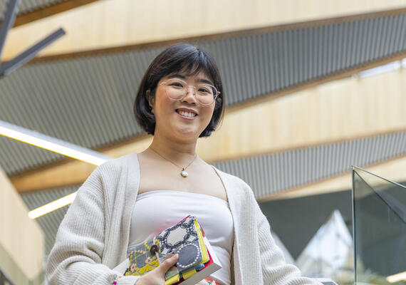 Deakin international student Dasha standing on stairs at the Deakin Burwood Campus.