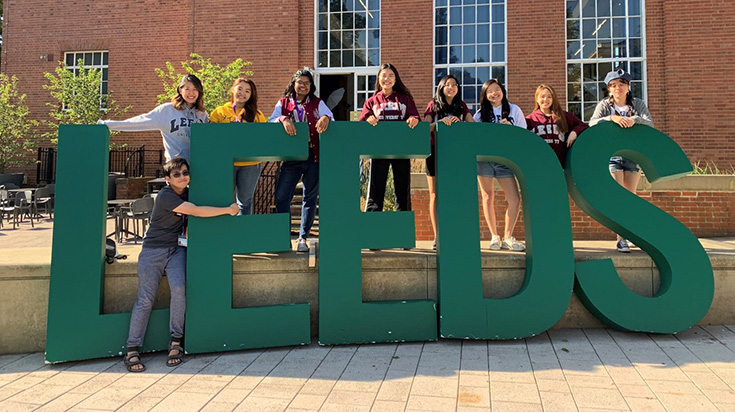 Students in front of a big LEEDS sign