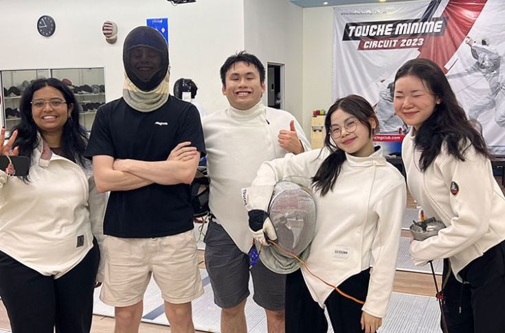 Luong and friends in fencing uniforms