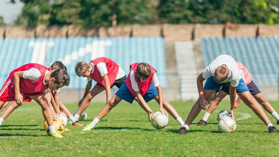 Group of soccer players warming up before training.