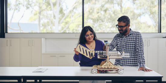Two researchers at a table working on a project.