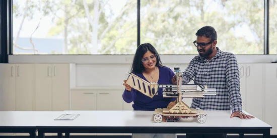 Two researchers at a table working on a project.