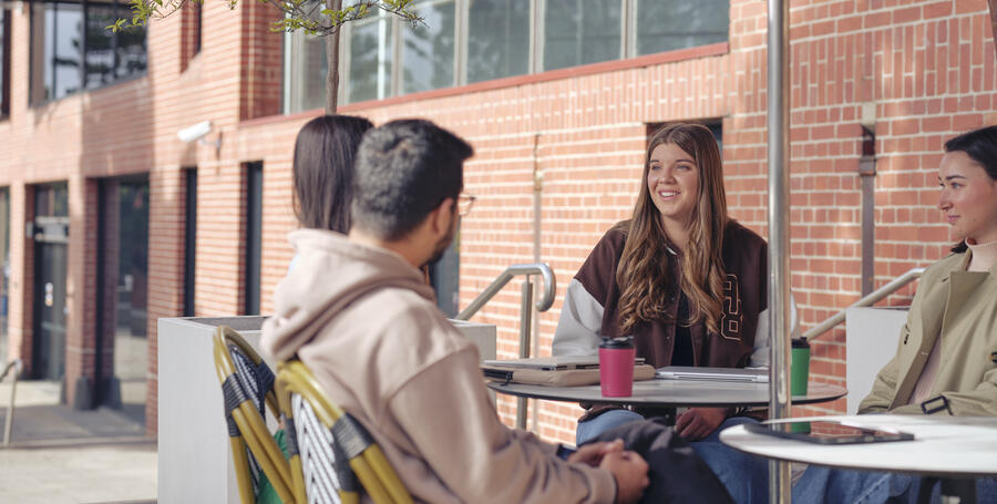 A group of Deakin students socialise at the Geelong Waterfront campus cafe