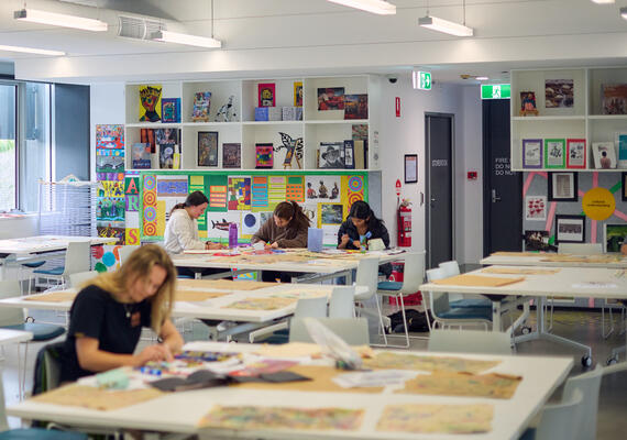 Long shot of a classroom with student teacher working at a table