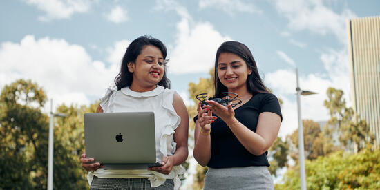 Two female students with a drone