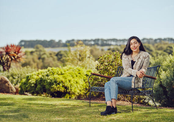 A Deakin MBA student on a bench.