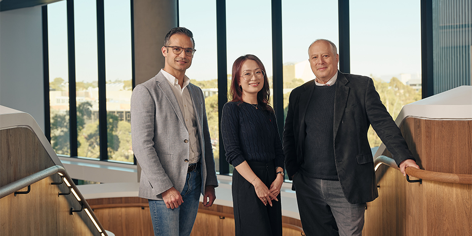 Three graduate research supervisors smiling 