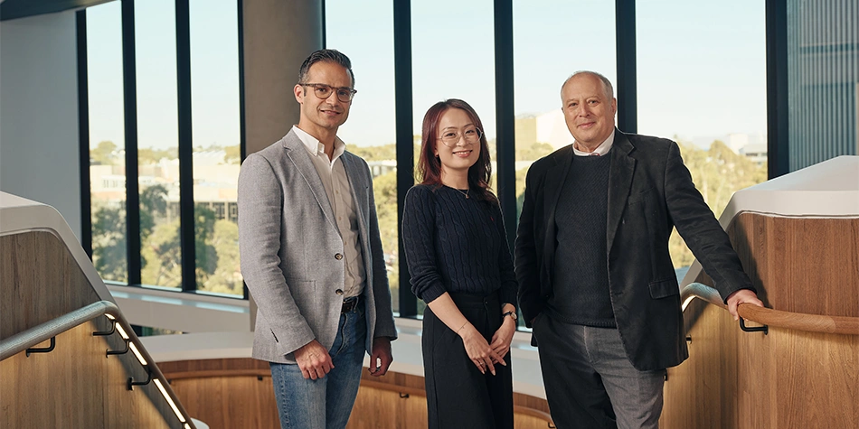 Three graduate research supervisors smiling 
