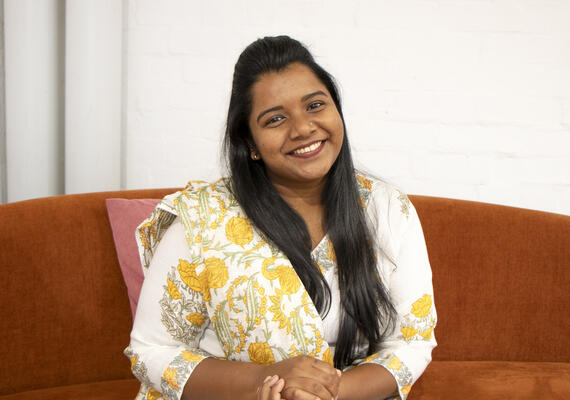 Deakin international student Mallika Adhav sitting and smiling.