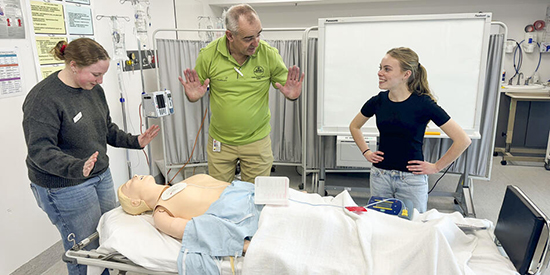 Three Deakin medical students in a simulation room