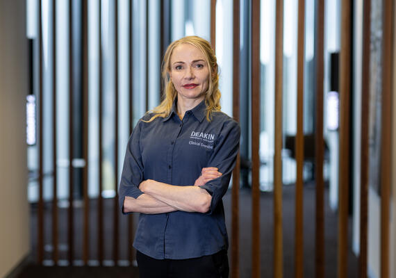 Photo of Niamh Mundell on campus crossing arms.