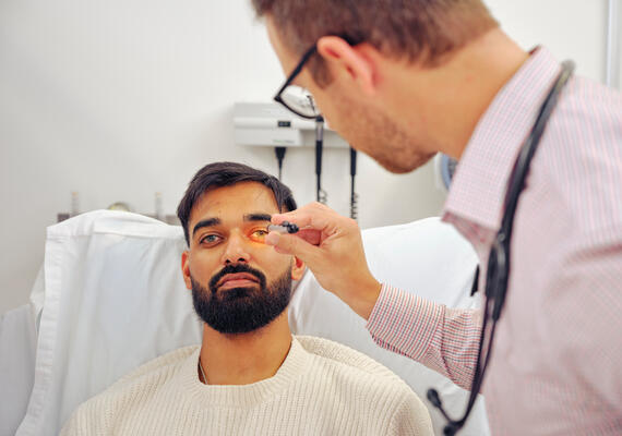 Deakin student examining a patient's eye.