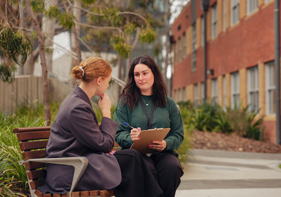 Health professional and patient meeting in hospital environment.