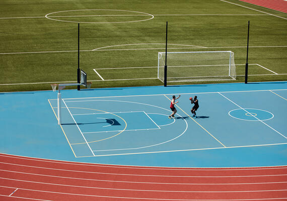 Deakin campus sports court and facilities with students practising basketball.