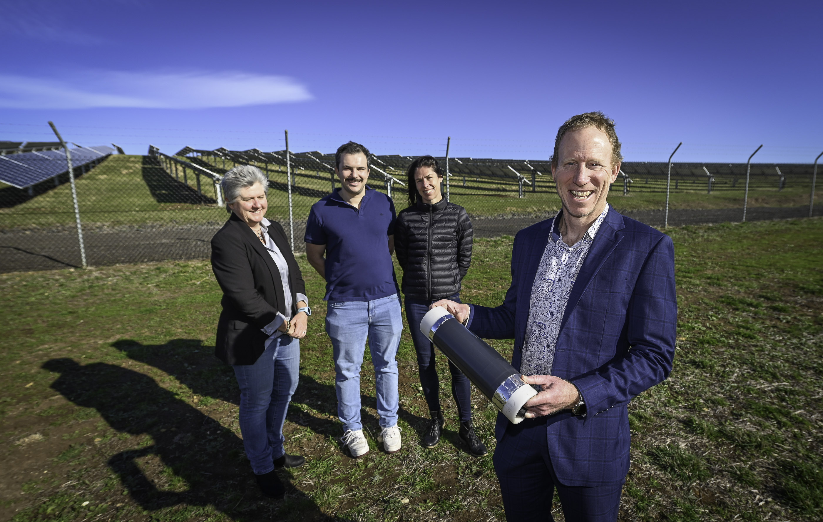 Four researchers standing near the Deakin solar farm.