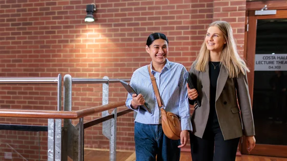 Two students walking to a lecture theatre. 