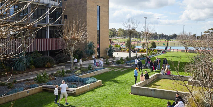 Deakin students walk outside at Deakin Waurn Ponds Campus.