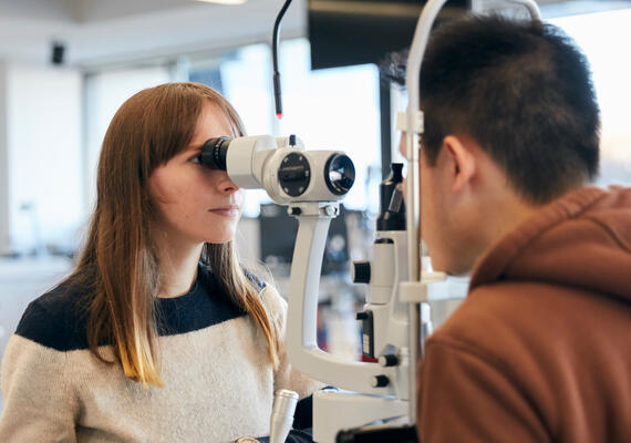 Deakin optometry student practicing eye test on campus. 