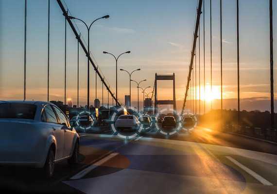 Cars driving on a bridge at sunset
