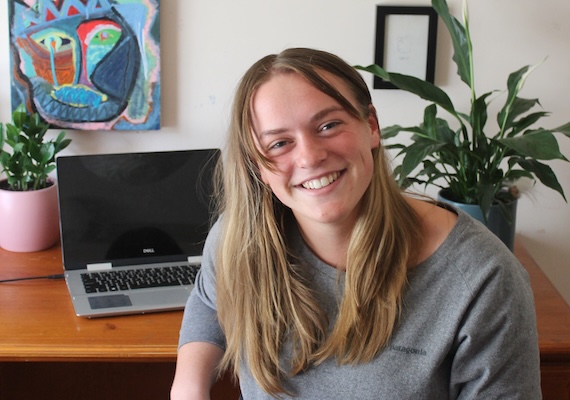 Deakin Bachelor of Communication (Public Relations) graduate Lauren Brown at a desk with a laptop.