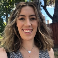 A headshot of Natasha Fridey smiling at the camera.