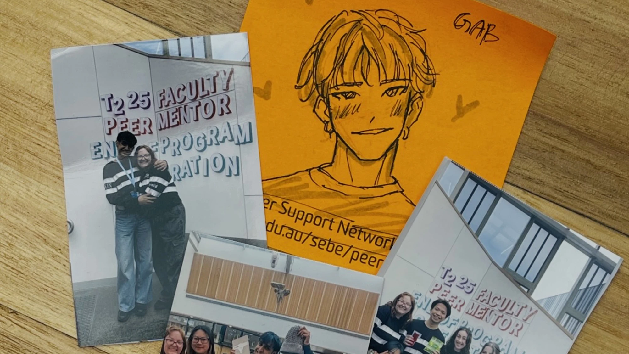 Printed photographs of Gab and friends alongside an illustration on orange paper of Gab's face