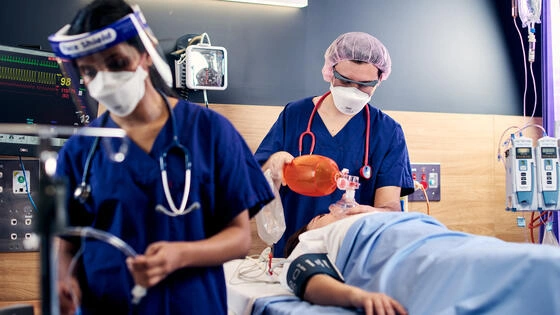 Deakin graduate diploma of intraoperative nursing students in clinical hospital setting with a patient.