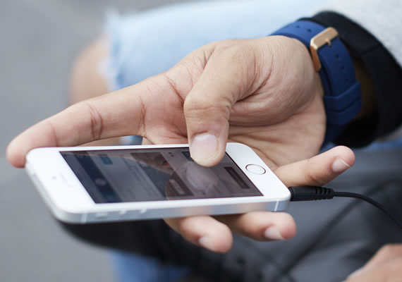A person scrolling on their mobile phone.