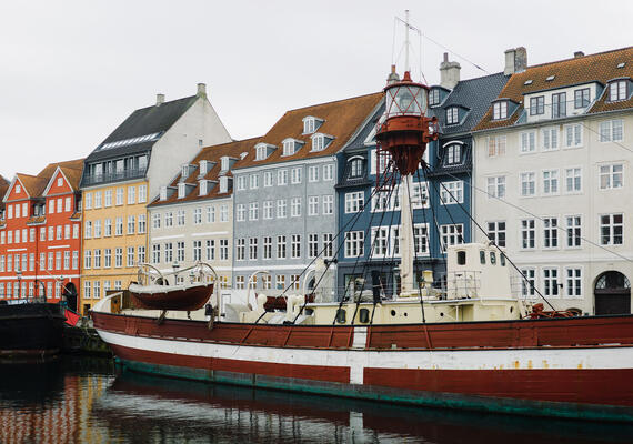 A boat in front of the buildings of Nyhavn in Copenhagen, Denmark.