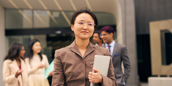 Postgraduate business students outside a building at the Deakin Melbourne Burwood Campus.