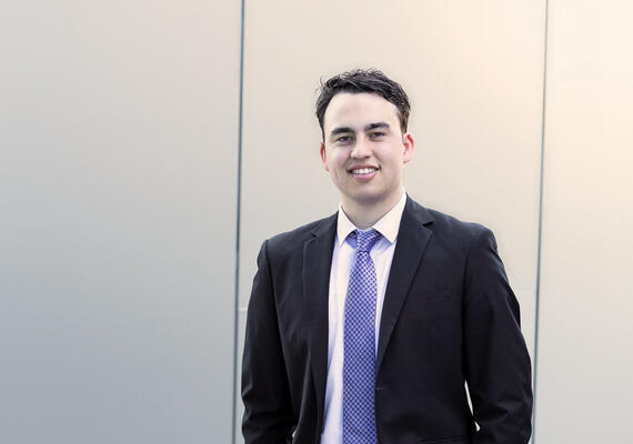 A profile image of Deakin Bachelor of Communication student Mitchell Clarke, wearing a suit and tie.