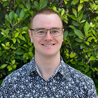 A headshot of Pat Hearne smiling at the camera.