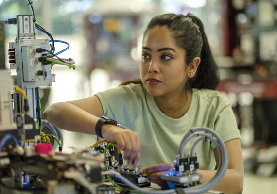 A Deakin student working on a piece of equipment