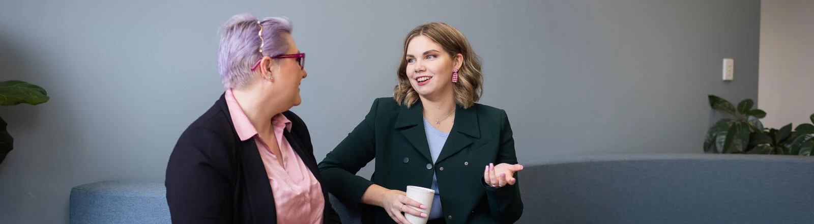 A Deakin master of business student sits with another student talking
