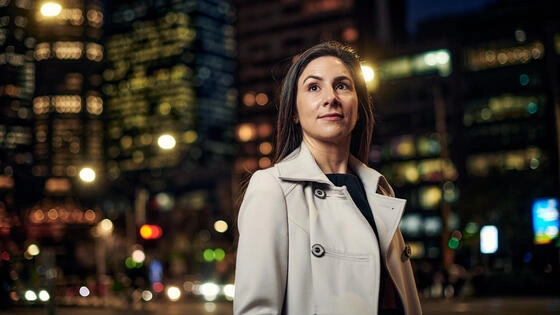 A Deakin MBA student in the city at night.