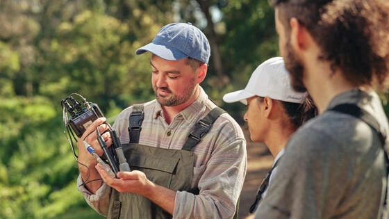 Deakin master of sustainability students in the field using equiptement for tests.