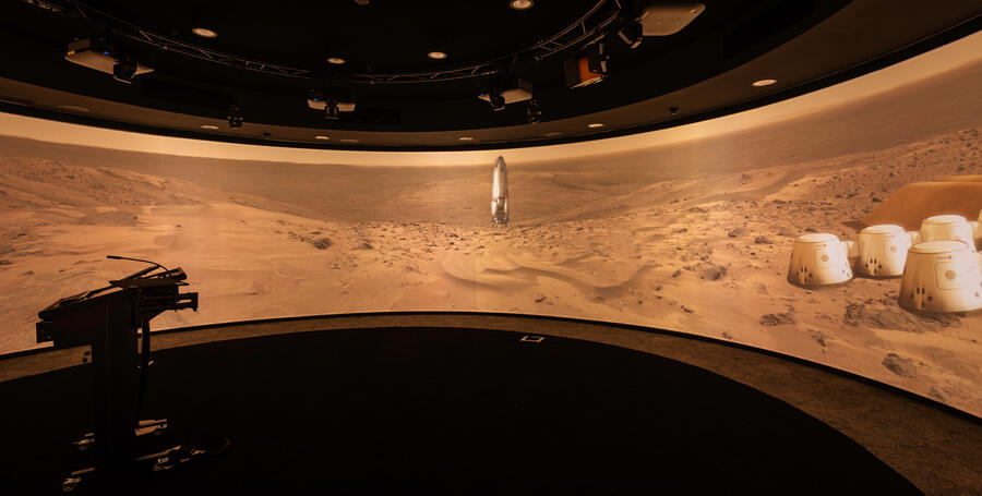 Students immersed in the 360-degree learning space with a planet landscape on screen
