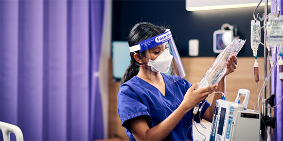 Deakin student nurse assessing IV bag.