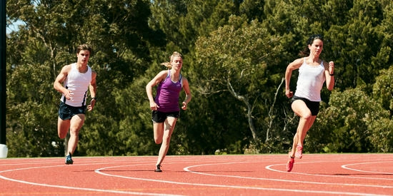 Three Deakin University elite athlete students run on Deakin Geelong Waurn Ponds running track