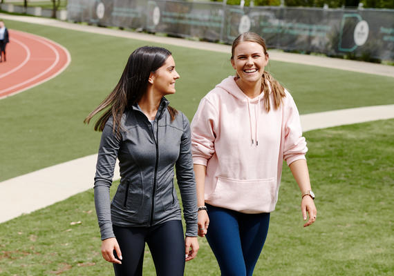 two athletes walk together near Waurn Ponds running track