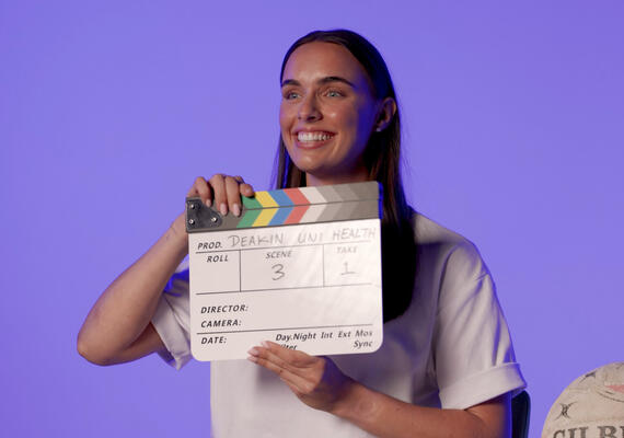 Person holding film set smiling
