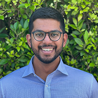 A headshot of Sid Sharma smiling at the camera.