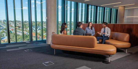 Students on a set of couches, participating in client-facing accounting and finance scenarios.