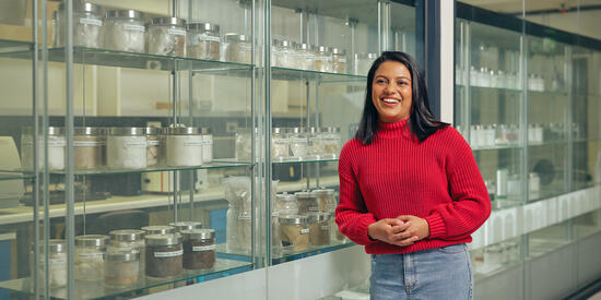 Graduate researcher Limna Shaji standing in a lab.