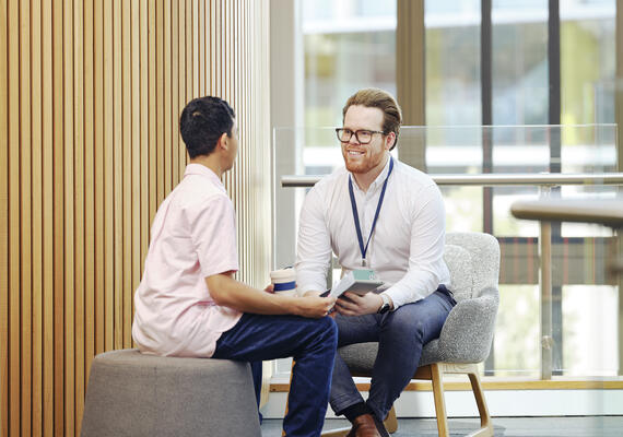A staff member providing advice to a Deakin student