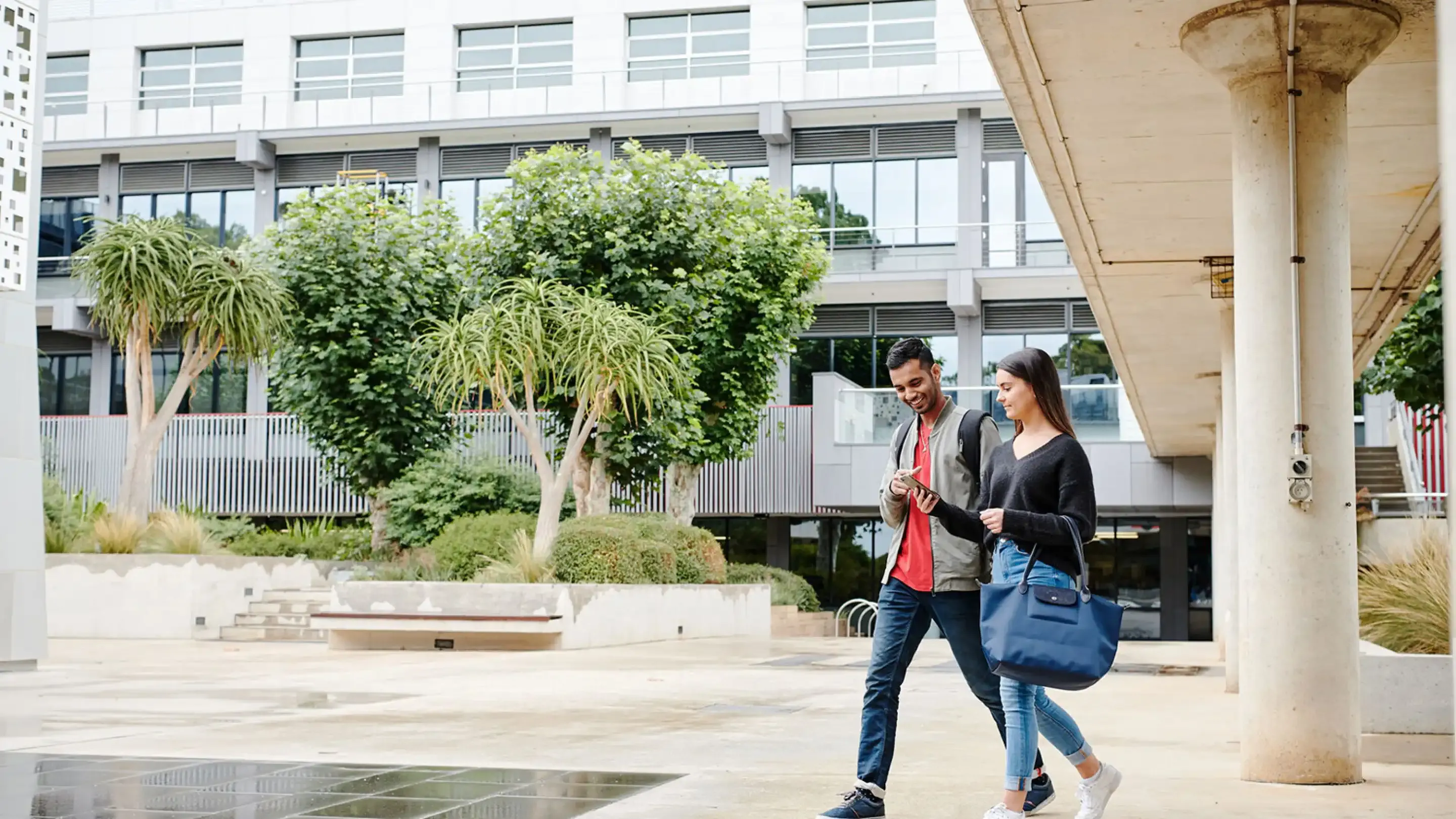 Two students walking across campus.